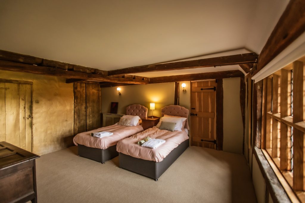 Whitfield House gold bedroom set up with twin beds. 