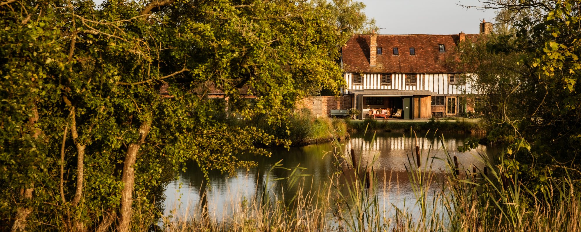 Whitfield House viewed across the lake in the gardens.