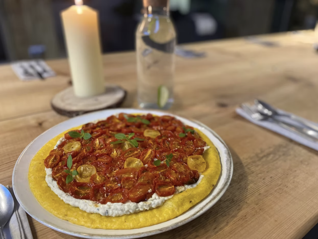 Slow roast tomato, confit garlic butterbean & polenta tart from Laura Paine.