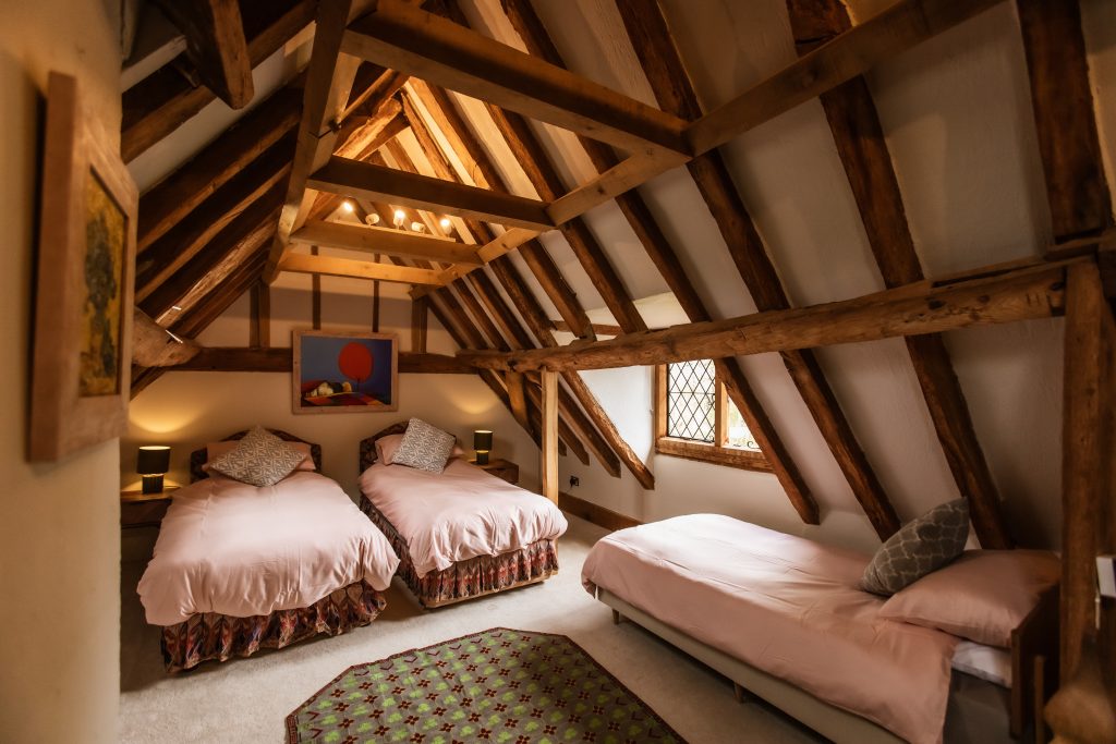 Whitfield house secret room quad sharing - shows 3 beds in the rafters of the roof